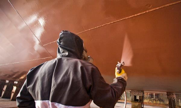 Man spraying container